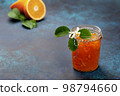 orange jam in a glass jar 98794660