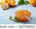 orange jam in a glass jar 98794662
