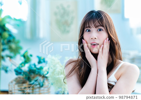 Young woman suffering from face care 98794871