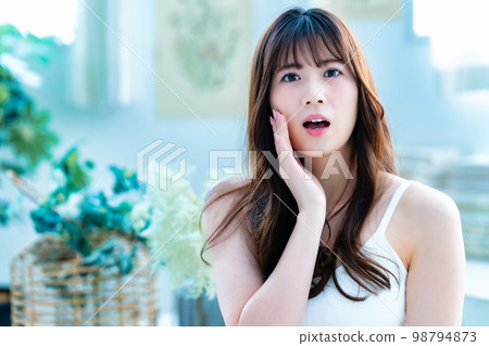 Young woman suffering from face care Young woman suffering from face care 98794873