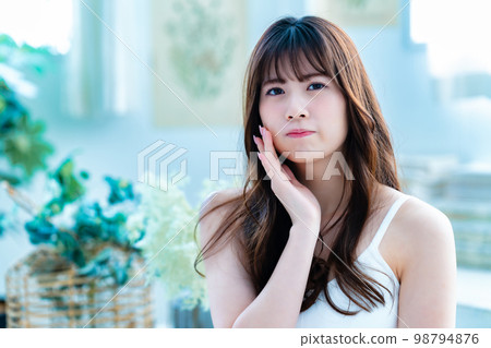 Young woman suffering from face care 98794876