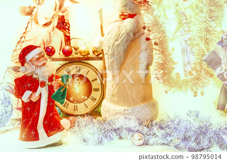 Two Santa Claus and vintage clock in golden silver Christmas New Year lights  98795014