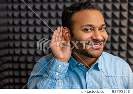 Smiling young man having a hearing checkup and looking contented 98795168