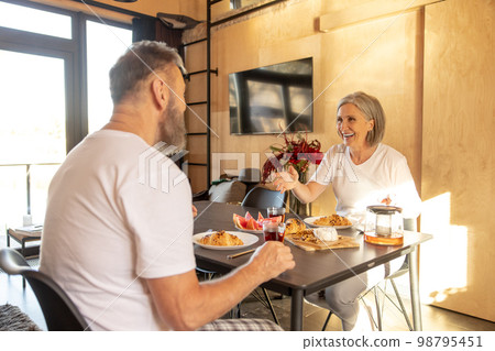 Couple having healthy breakfast at home Couple having healthy breakfast at home 98795451