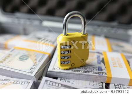 Yellow code lock on dollars in the suitcase, close-up Yellow code lock on dollars in the suitcase, close-up 98795542