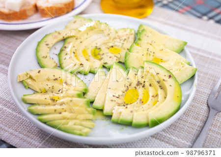 ripe avocado pulp cut into pieces sprinkled with lemon juice on a plate ripe avocado pulp cut into pieces sprinkled with lemon juice on a plate 98796371