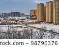 Winter urban landscape. New Residential buildings, snow covered land and privat houses 98796376