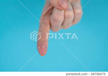 Woman holding contact lens on blue background. Woman holding contact lens on blue background. 98796679