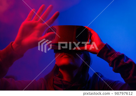 person wearing virtual reality glasses gets experience of gaming and entertainment 98797612