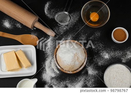 Flat lay composition with ingredients for baking pie on black table 98798767
