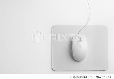 Modern wired optical mouse and pad on white background, top view 98798775