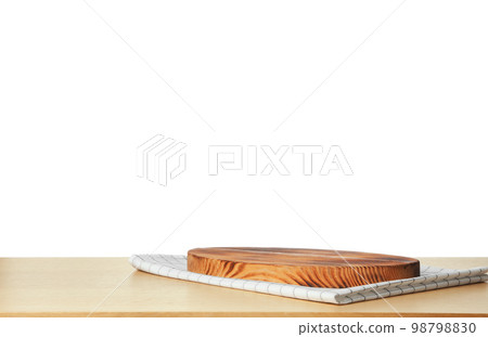 Folded kitchen towel and cutting board on wooden table. Space for design Folded kitchen towel and cutting board on wooden table. Space for design 98798830