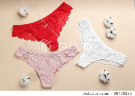 Women's underwear and cotton flowers on beige background, flat lay 98798886