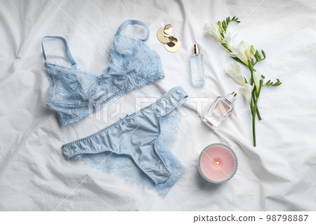 Flat lay composition with sexy women's underwear on white fabric Flat lay composition with sexy women's underwear on white fabric 98798887
