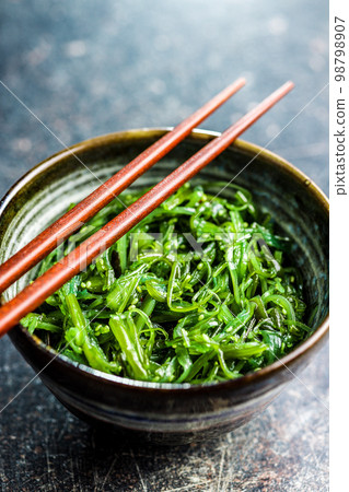 Green seaweed. Japanese wakame salad in bowl. Green seaweed. Japanese wakame salad in bowl. 98798907