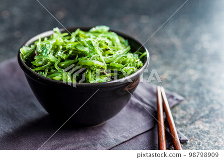 Green seaweed. Japanese wakame salad in bowl. Green seaweed. Japanese wakame salad in bowl. 98798909