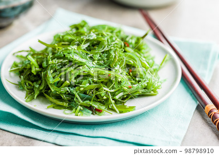 Green seaweed. Japanese wakame salad on plate. Green seaweed. Japanese wakame salad on plate. 98798910