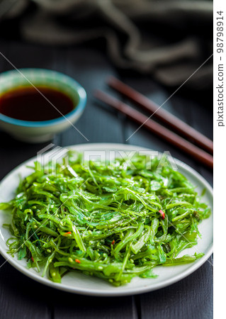 Green seaweed. Japanese wakame salad and soy sauce. Green seaweed. Japanese wakame salad and soy sauce. 98798914
