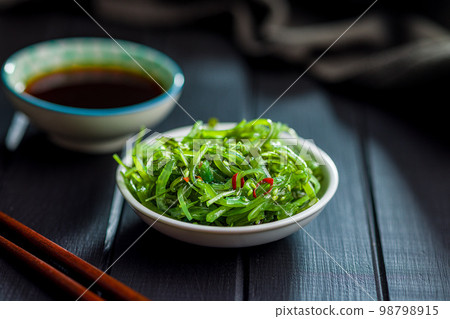 Green seaweed. Japanese wakame salad in bowl. Green seaweed. Japanese wakame salad in bowl. 98798915