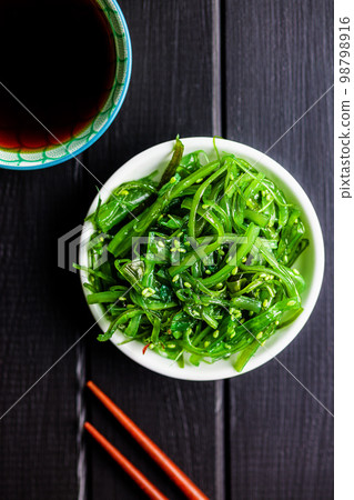 Green seaweed. Japanese wakame salad and soy sauce. Top view. 98798916