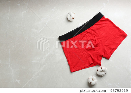 Men's underwear and cotton flowers on light grey marble background, flat lay Men's underwear and cotton flowers on light grey marble background, flat lay 98798919