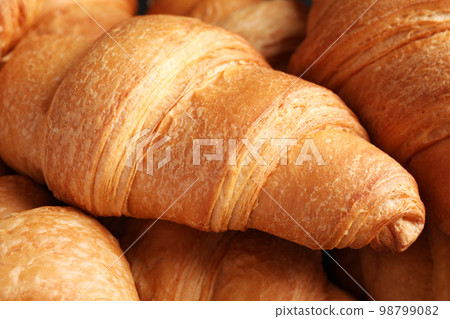 Tasty fresh croissants as background, closeup view 98799082