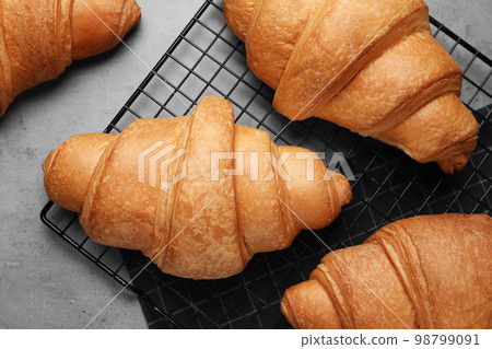 Tasty fresh croissants on light grey table, flat lay Tasty fresh croissants on light grey table, flat lay 98799091