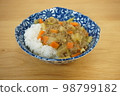 Dry curry with root vegetables and green onions 98799182