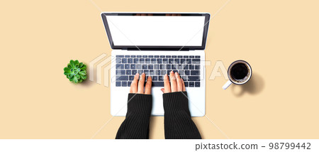 Person using a laptop computer 98799442