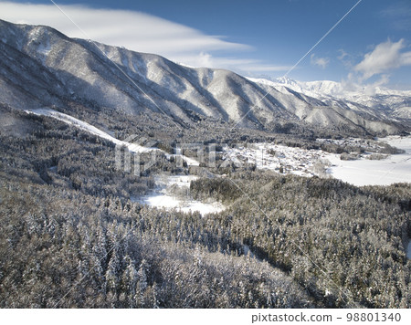 View of beautiful snowy forest, Oyami Marsh and Hakuba from Sanozaka Pass, Hakuba Village, Nagano Prefecture (Aerial shot by drone) View of beautiful snowy forest, Oyami Marsh and Hakuba from Sanozaka Pass, Hakuba Village, Nagano Prefecture (Aerial shot by drone) 98801340