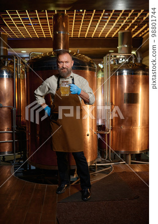 Brewery technologist tasting fresh craft beer at microbrewery plant Brewery technologist tasting fresh craft beer at microbrewery plant 98801744