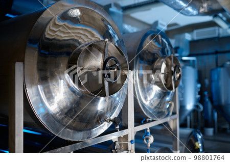 Industrial interior of modern craft brewery with metal beer tanks Industrial interior of modern craft brewery with metal beer tanks 98801764