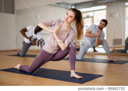Woman doing yoga postures on group training 98802732