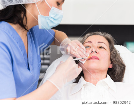 Mature woman getting ready for plastic surgery closeup 98802942