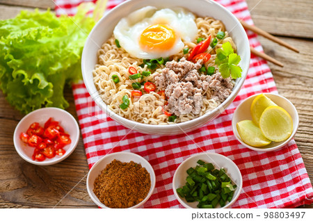 noodles bowl with boiled egg minced pork vegetable spring onion lemon lime lettuce celery and chili on table food , instant noodles cooking tasty eating with bowl - noodle soup noodles bowl with boiled egg minced pork vegetable spring onion lemon lime lettuce celery and chili on table food , instant noodles cooking tasty eating with bowl - noodle soup 98803497