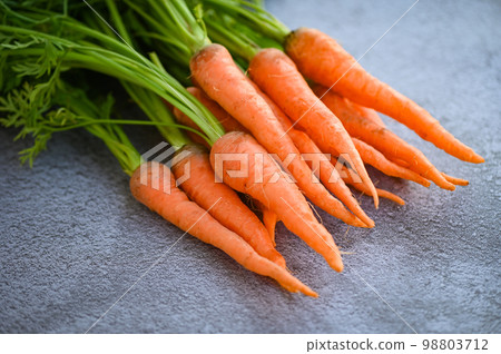 carrot on table background, Fresh and sweet carrots for cooking food fruits and vegetables for health concept, baby carrots bunch and leaf carrot on table background, Fresh and sweet carrots for cooking food fruits and vegetables for health concept, baby carrots bunch and leaf 98803712