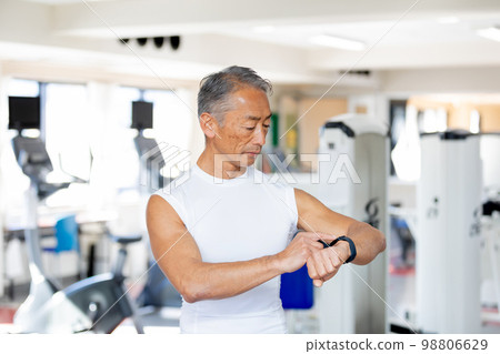 Senior man managing health with smart watch 98806629