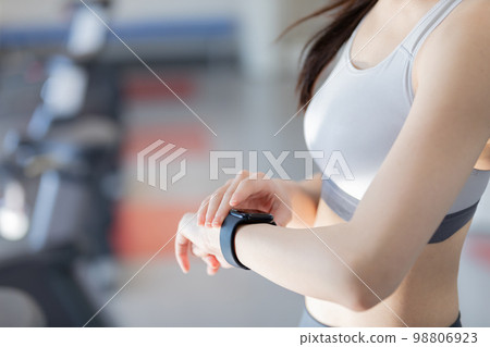 Young woman managing her health with a smartwatch Young woman managing her health with a smartwatch 98806923