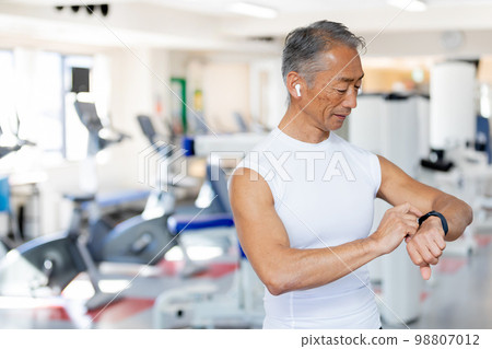 Senior man managing health with smart watch 98807012