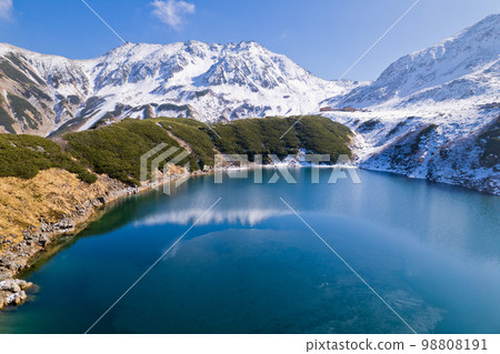 Drone aerial photography Tateyama Murodo's Mikuriga pond in early winter Tateyama mountain range and Mt. Jodo Drone aerial photography Tateyama Murodo's Mikuriga pond in early winter Tateyama mountain range and Mt. Jodo 98808191