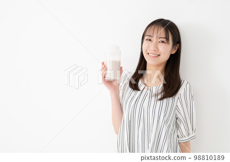 Woman drinking protein milk diet 98810189