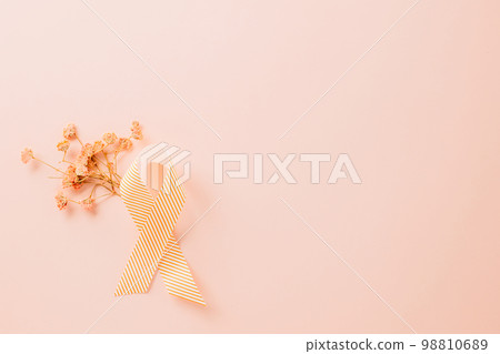 Pink awareness ribbon sign and paper card flower of World Cancer Day on pink background with copy space, concept of medical and health care support, Breast cancer awareness concept, 4 February Pink awareness ribbon sign and paper card flower of World Cancer Day on pink background with copy space, concept of medical and health care support, Breast cancer awareness concept, 4 February 98810689