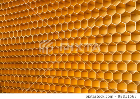 Honey color golden honeycomb. Abstract texture background full frame, design wall, three quarter front view. 98811565