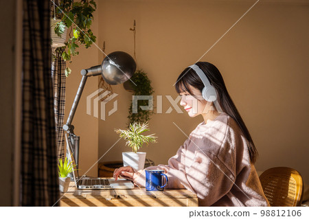 一邊聽音樂一邊使用電腦的女人 98812106