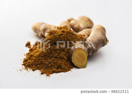 Autumn turmeric rhizome and turmeric powder on white background Autumn turmeric rhizome and turmeric powder on white background 98812511