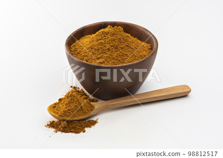 Turmeric powder and wooden spoon on white background 98812517