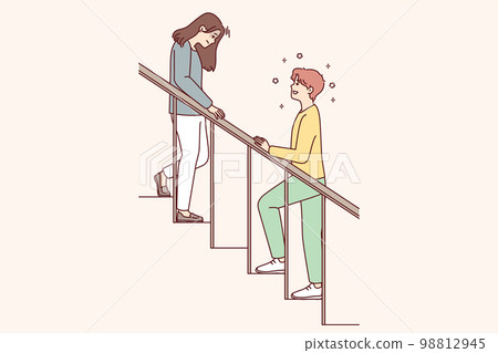 Woman with head down goes down stairs and man is waiting for beloved girlfriend Woman with head down goes down stairs and man is waiting for beloved girlfriend 98812945