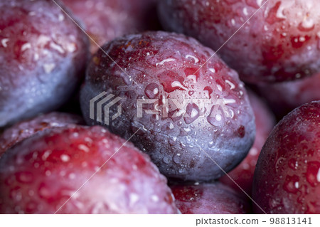 Ripe plums of dark color on the table 98813141