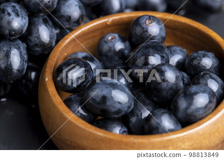 washed ripe black grapes covered with drops of water washed ripe black grapes covered with drops of water 98813849
