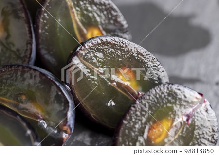 sweet ripe black grapes cut in half 98813850